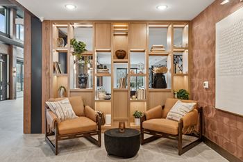 A living room with two chairs and a table.